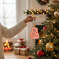 Mellow Monkey pink hand-painted guitar ornament with You've Got A Friend in Me text hanging on a Christmas tree.