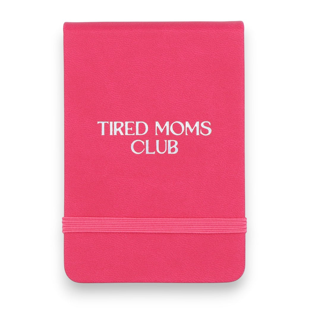Mellow Monkey pink leatherette pocket journal with Tired Moms Club embossed on the front and an elastic closure band.
