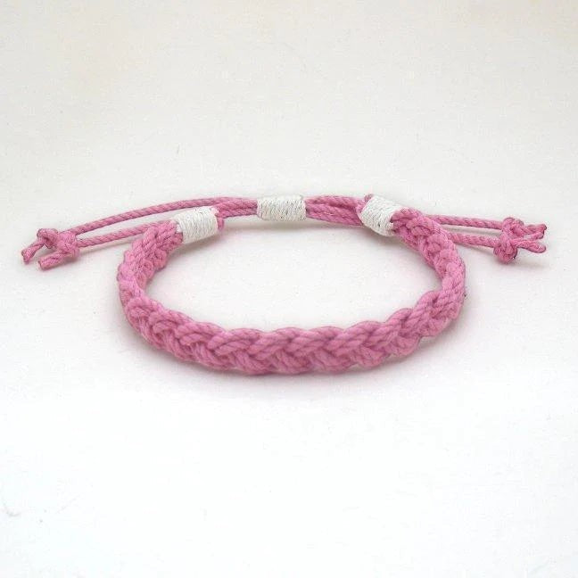 Mellow Monkey pink woven cotton nautical anklet with adjustable sliding knot closure on a white background.