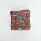 Mellow Monkey cocktail napkins featuring Kim Hovell poinsettia floral artwork in red and green for holiday parties.