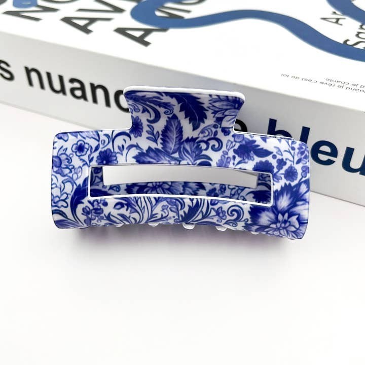 Mellow Monkey hair claw clip featuring a blue and white porcelain-inspired floral pattern on a white background.