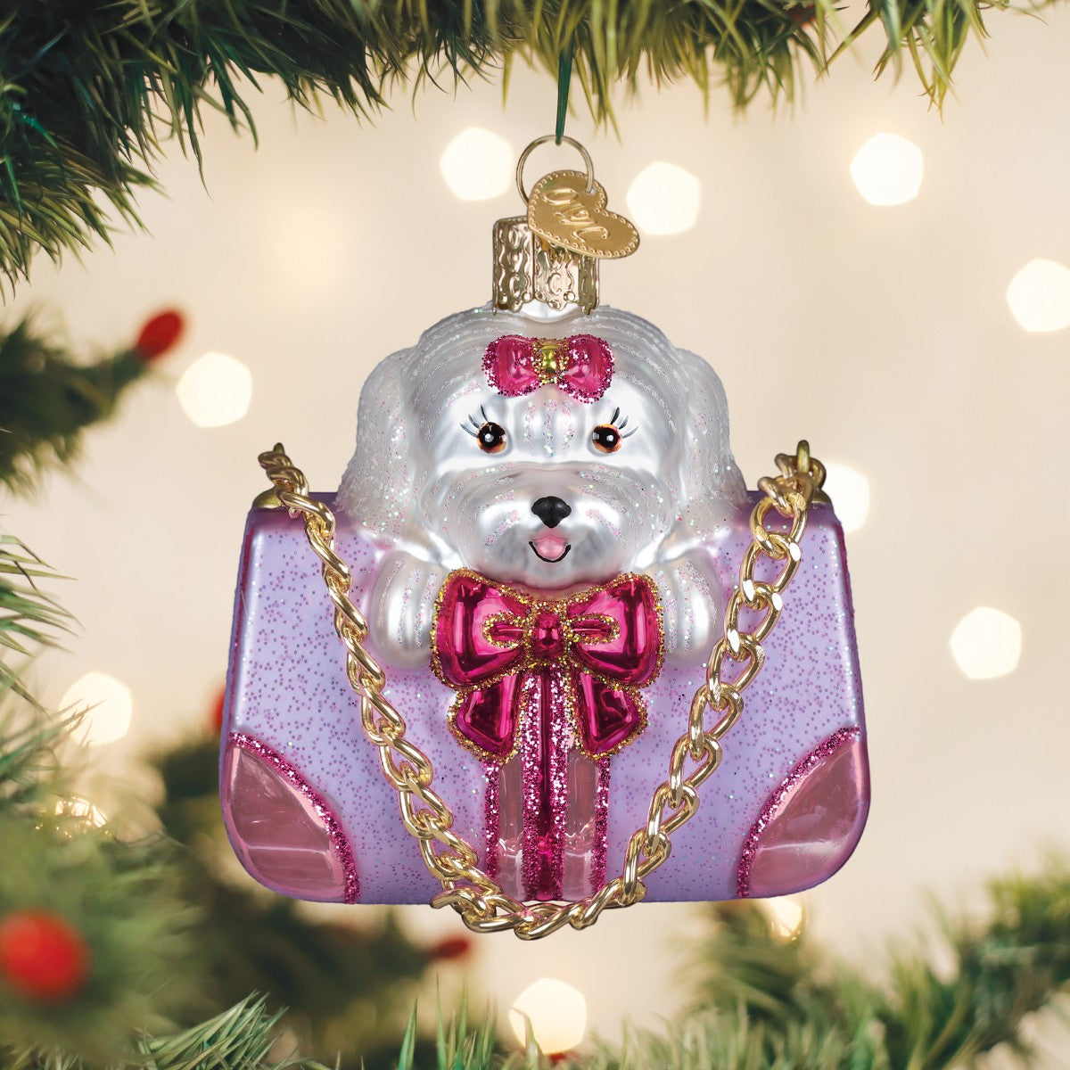 Mellow Monkey Posh Pup In Purse blown glass Christmas ornament with white dog, pink bow, and purple glittery purse.