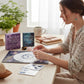 Mellow Monkey Practical Magic Mini Mega Kit with crystals, astrological chart, stickers, and guide on a desk.