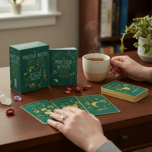 Mellow Monkey The Practical Witches Spell Deck with illustrated cards, mini guide, and keepsake box on a wooden desk.