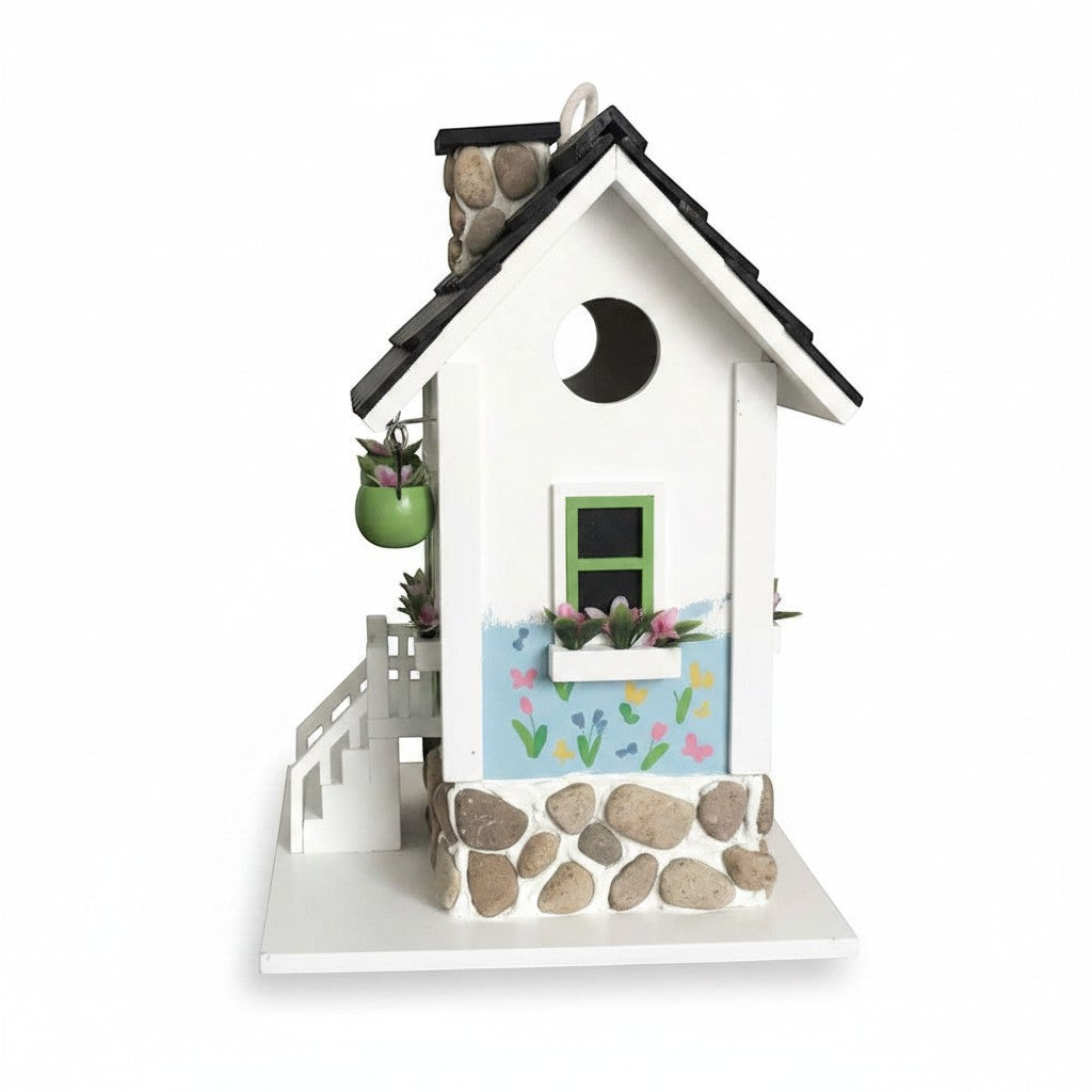 Mellow Monkey Primrose Cottage birdhouse with white exterior, black roof, stone chimney, and hand-painted floral motif.
