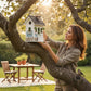 Mellow Monkey Primrose Cottage birdhouse, white with green trim, floral motif, river rock base, hanging cord.