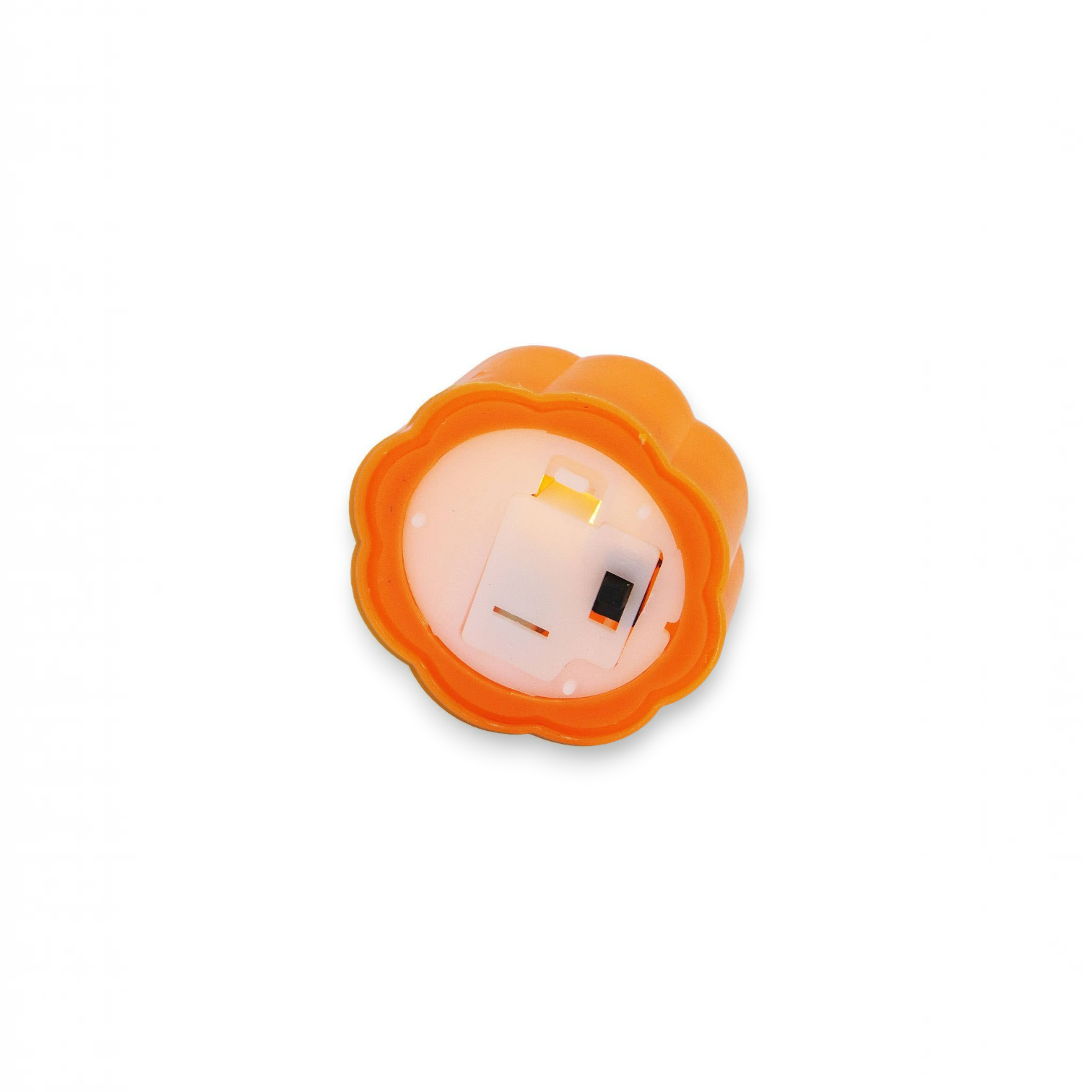 Mellow Monkey mini orange plastic pumpkin LED tealight candle showing the battery compartment and on-off switch