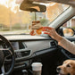 Mellow Monkey Pumpkin Spice paw-shaped car air freshener hanging in a vehicle with a golden retriever passenger