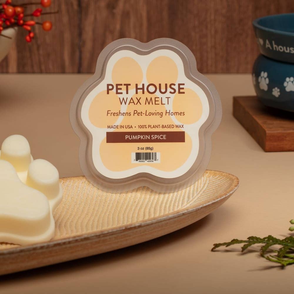 Mellow Monkey Pumpkin Spice wax melt in a paw-shaped container on a decorative dish for pet-loving homes