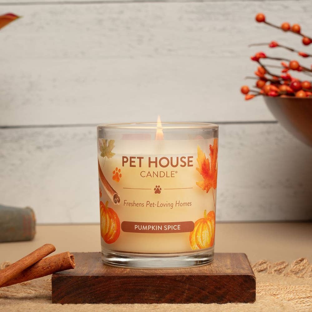 Mellow Monkey Pumpkin Spice Pet House Candle in a glass jar with autumn leaf and pumpkin graphics on a wooden base