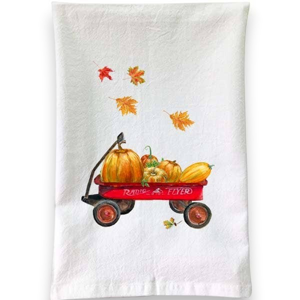 Mellow Monkey white cotton flour sack towel featuring a red Radio Flyer wagon filled with autumn pumpkins and leaves.