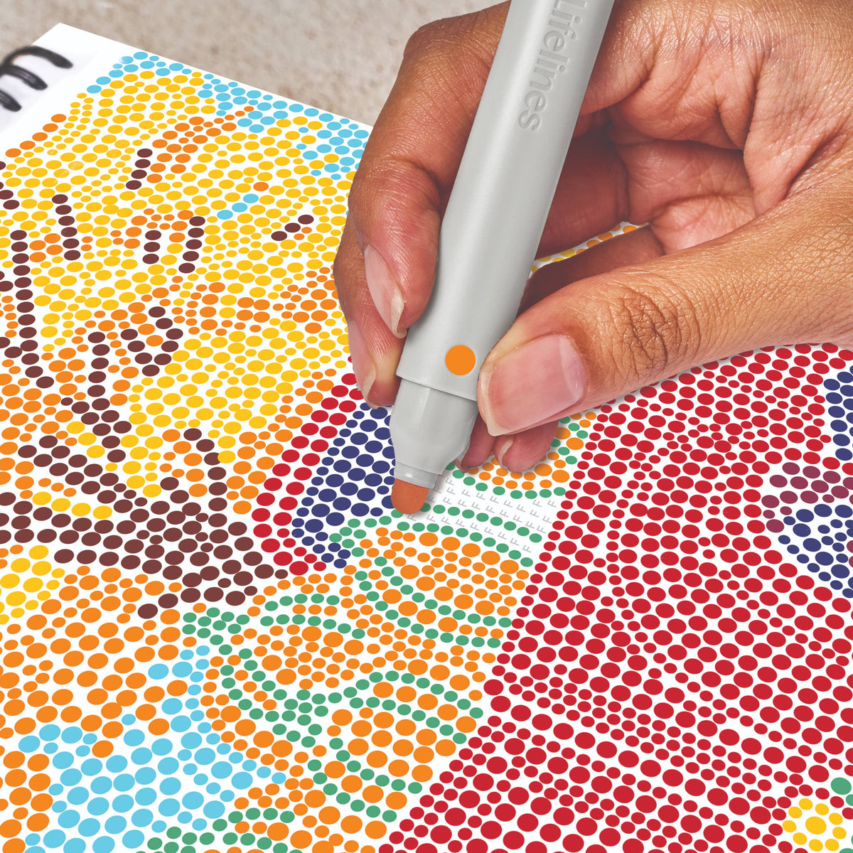 Mellow Monkey Pumpkins & Pastures FlowArt dot-by-letter activity pad with a hand using a marker to fill in dots.