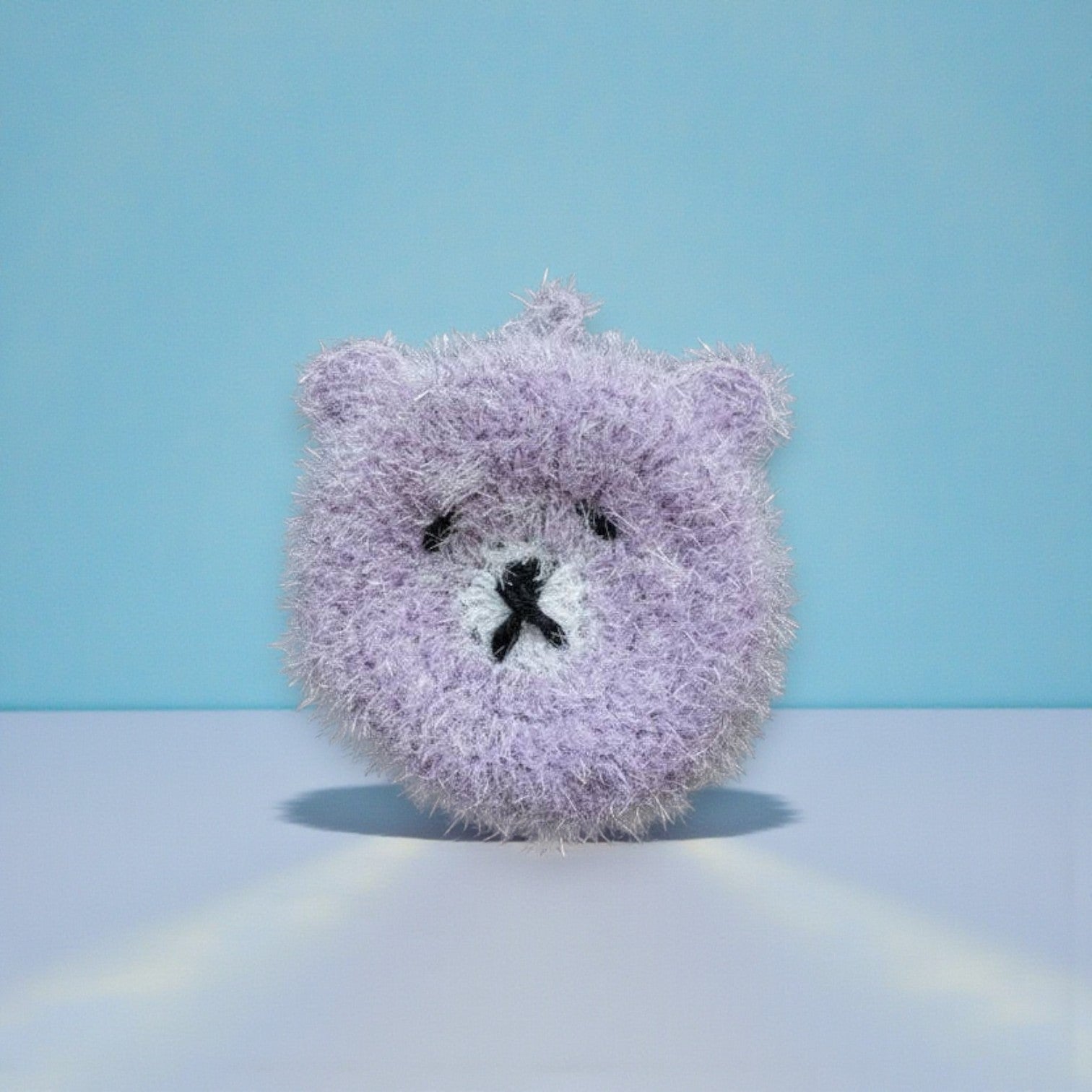 Mellow Monkey Good News Bears scrubby sponge in soft purple with black embroidered face. Dual-sided for versatile cleaning.