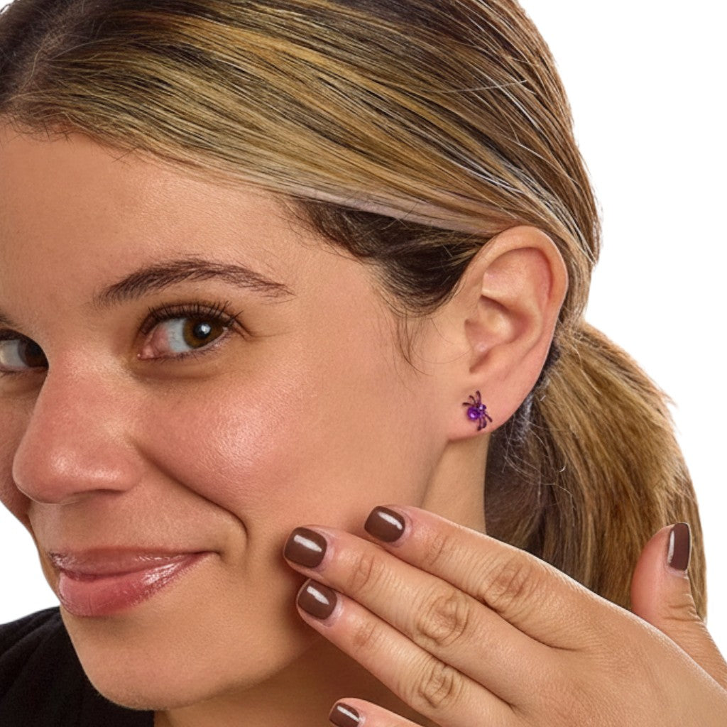 Mellow Monkey crystal spider stud earring in purple worn on a woman's earlobe