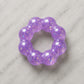 Mellow Monkey Purple Haze Feelzies sensory bracelet with glittery purple squishy texture on a marble surface.