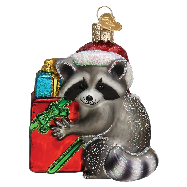 Mellow Monkey Jimothy raccoon Christmas ornament in blown glass, wearing a Santa hat and holding a red gift box.