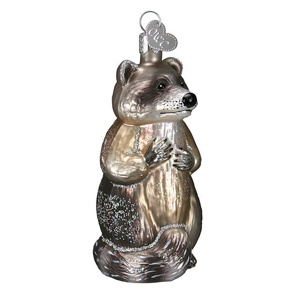 Mellow Monkey Raccoon Old World Christmas blown glass ornament, 3.5-inch, with glitter accents and a heart-shaped tag.