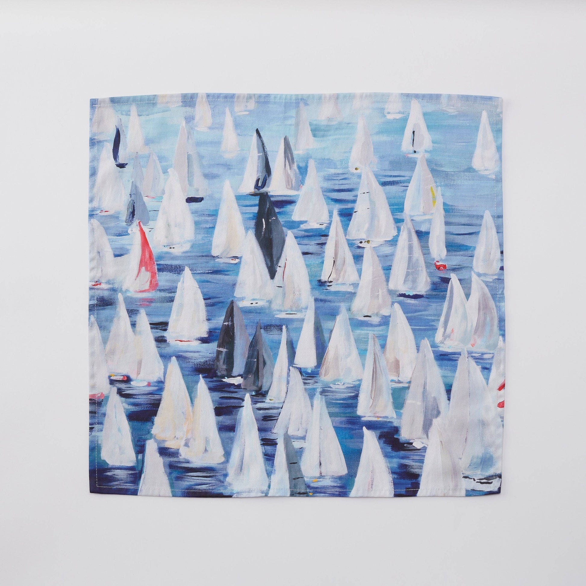 Mellow Monkey Race Day dinner napkins feature a painting of many sailboats on blue water. Set of 4 cotton napkins.