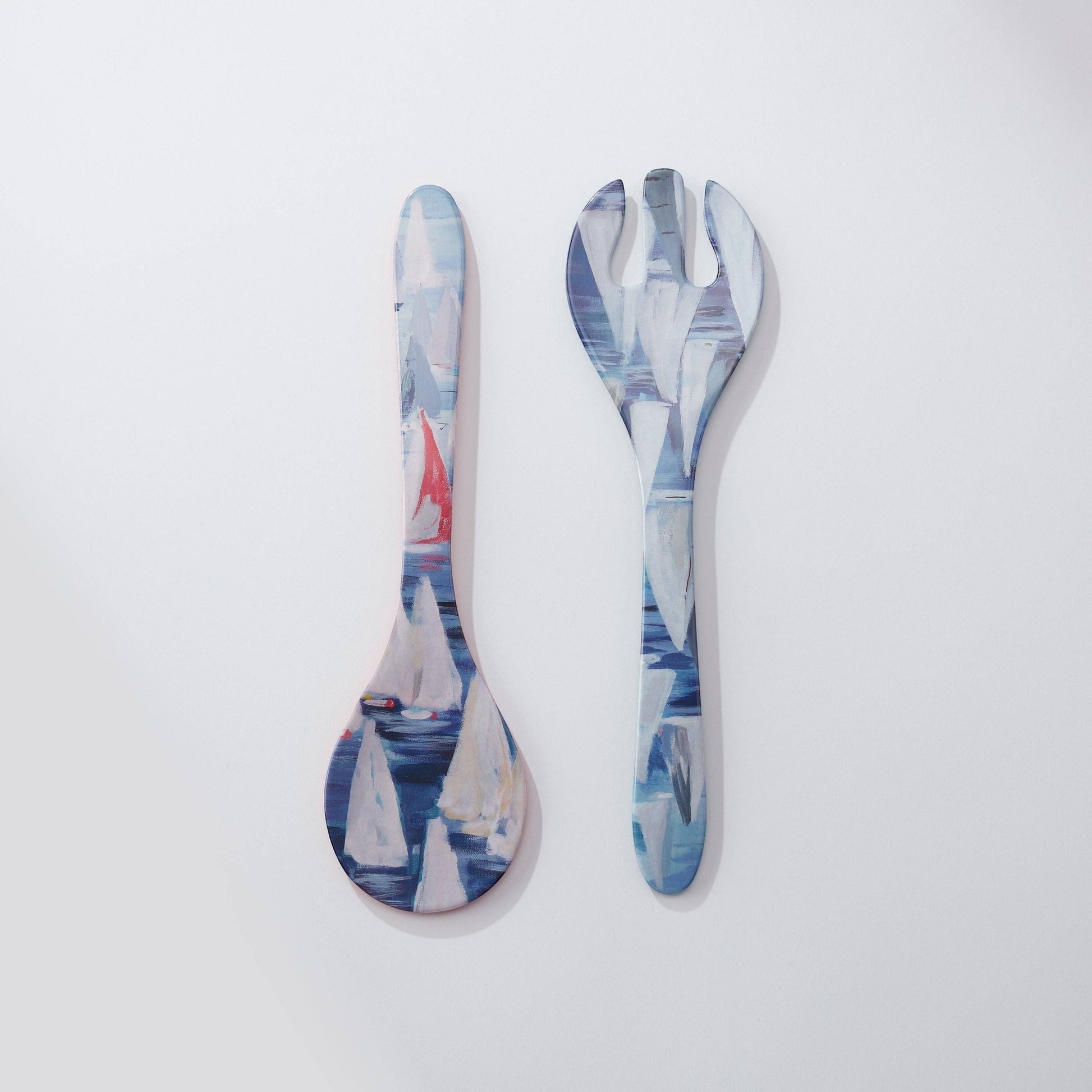 Mellow Monkey Race Day melamine salad servers featuring a nautical painting of sailboats on blue water. One server is a spoon, the other a fork.
