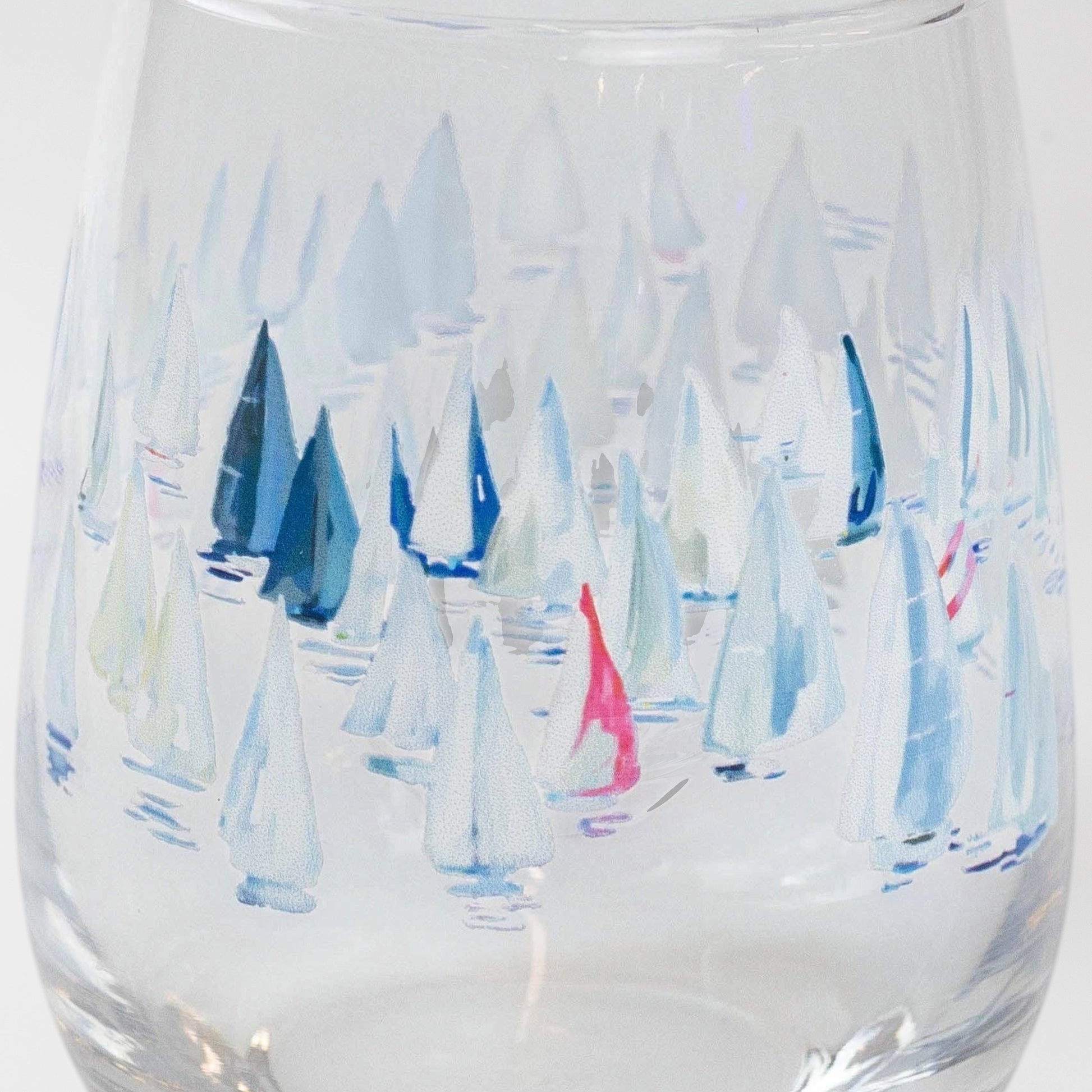 Mellow Monkey Race Day stemless wine glass with a watercolor print of sailboats in blue, white, and pink.