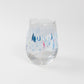 Mellow Monkey Race Day stemless wine glass with a watercolor print of sailboats in shades of blue and pink.