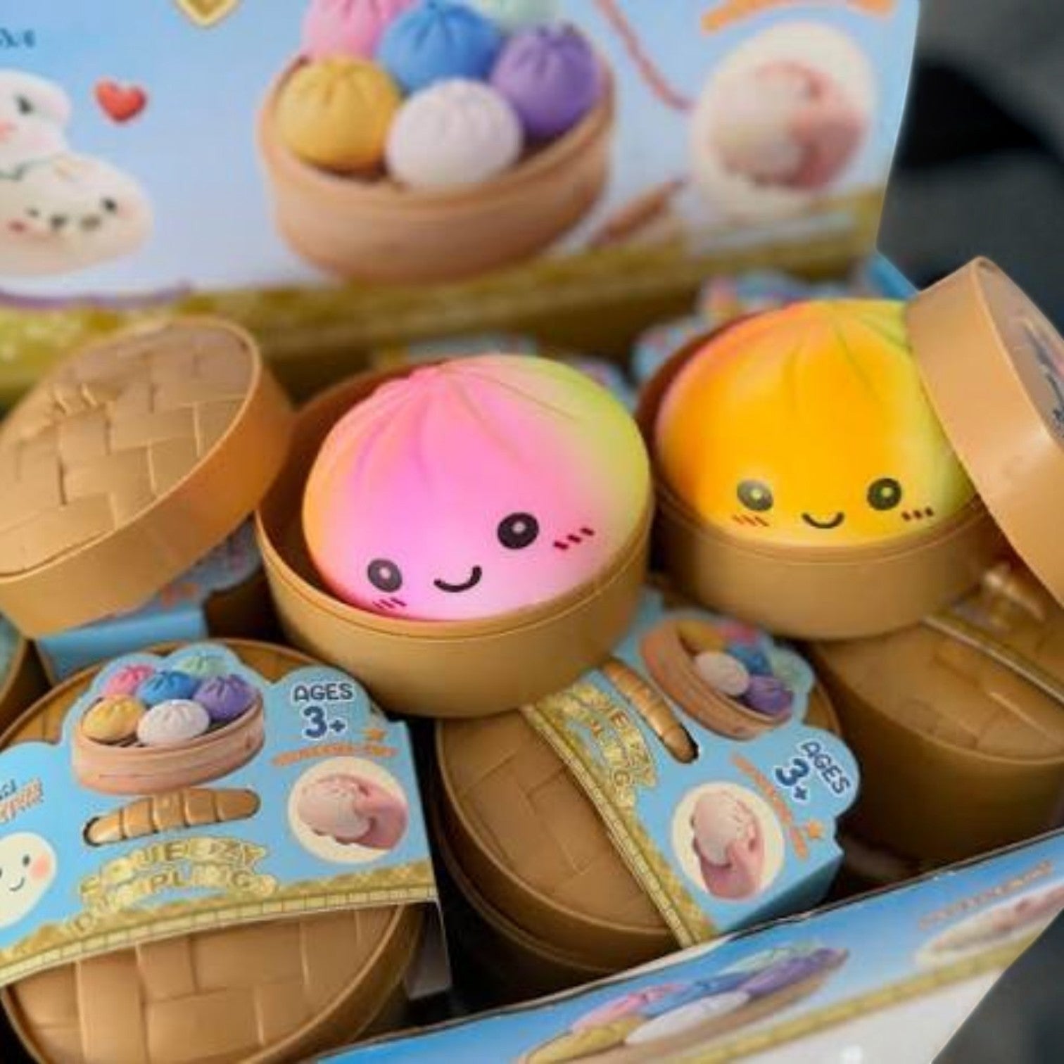 Mellow Monkey tie-dye rainbow dumpling sensory squeeze toy with a cute face in a miniature bamboo steamer container.