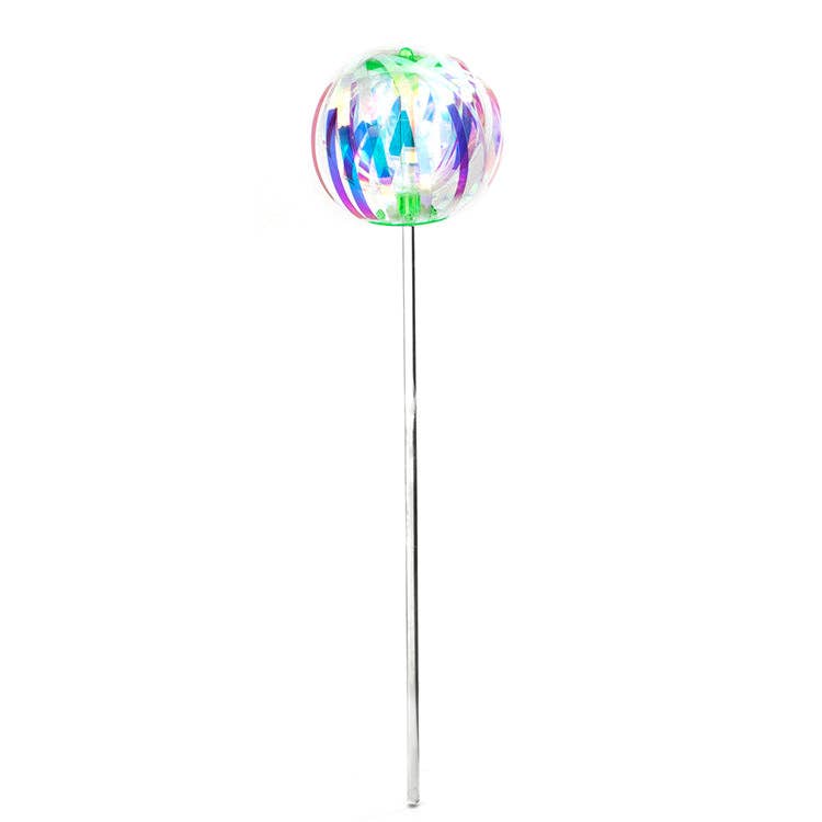 Mellow Monkey rainbow spinner toy featuring a clear spherical head with colorful ribbons on a long silver handle