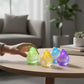 Mellow Monkey Raindrop Sugar Squishers in green, yellow, blue, and purple glittery gel on a wooden table.