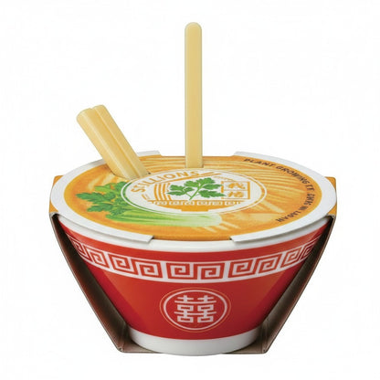 Mellow Monkey Ramen Garden plant growing kit in a red and white ceramic bowl with tiny chopsticks and scallion seeds.