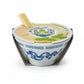 Mellow Monkey Ramen Garden Mitsuba plant growing kit in a white ceramic bowl with blue dragon pattern and chopsticks.