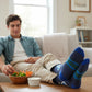 Mellow Monkey crew socks featuring an I Put Ranch On My Ranch graphic, worn by a man relaxing on a couch with veggies.