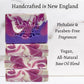 Mellow Monkey artisan raspberry ginger ale vegan soap bars with purple and white swirl patterns on a marble surface.