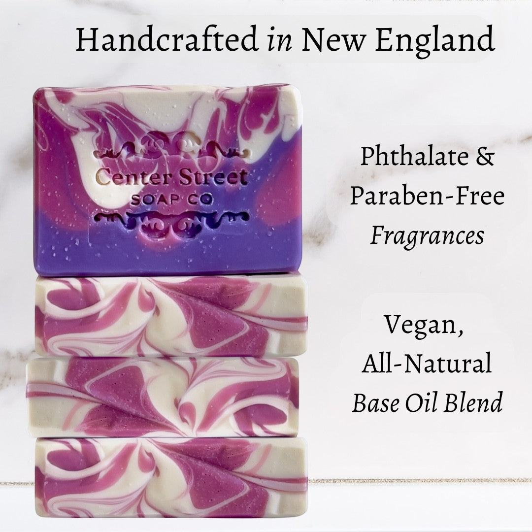 Mellow Monkey artisan raspberry ginger ale vegan soap bars with purple and white swirl patterns on a marble surface.