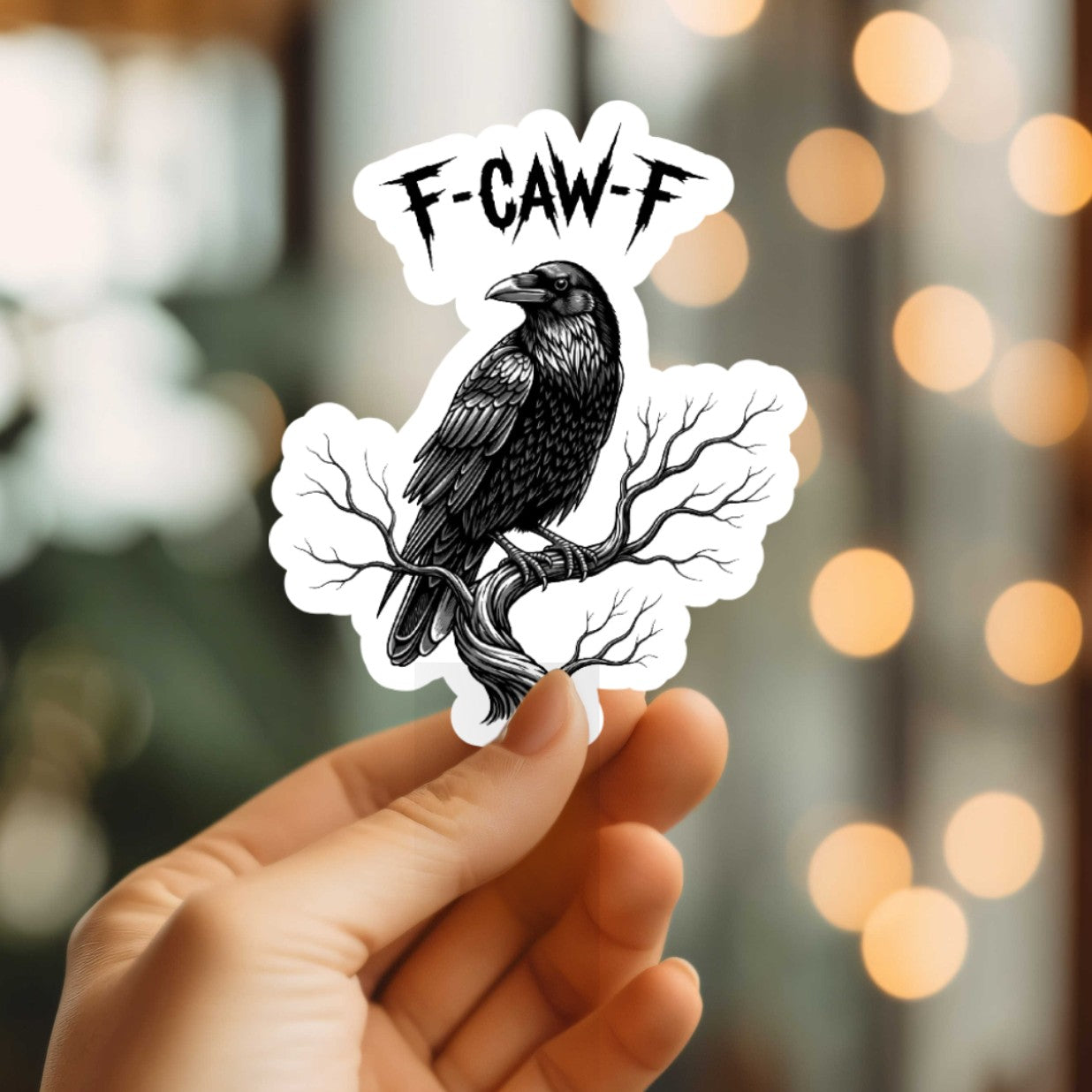 Mellow Monkey gothic raven vinyl sticker with jagged F-CAW-F lettering held against a blurred background