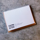 Mellow Monkey greeting card back view featuring Crimson and Clover Studio branding on textured recycled cardstock