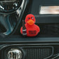Mellow Monkey red rubber duck holding a beer bottle with Quack Open a Cold One text on a car dashboard
