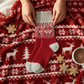 Mellow Monkey Red Confetti holiday crew sock with snowflake pattern on a matching festive blanket with gingerbread