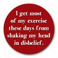Mellow Monkey 1.25 inch round red pin-back button with white text reading I get most of my exercise shaking my head