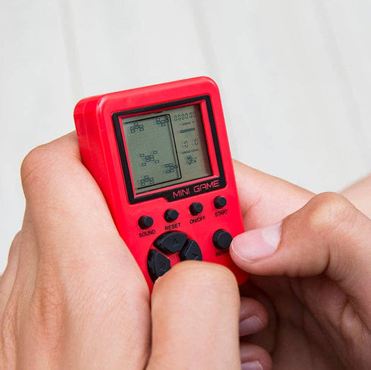 Mellow Monkey red portable pocket arcade game being held and played by hands