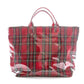 Mellow Monkey red tartan plaid tote bag made of durable nylon and PVC with a glossy finish for holiday shopping.