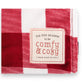 Mellow Monkey red and white plaid blanket with a stitched label reading Tis the Season to be Comfy and Cozy