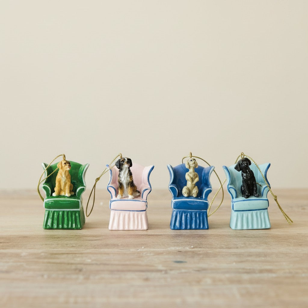 Mellow Monkey resin dog ornaments in vintage-style wingback chairs with pleated skirts and gold hanging cords