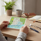 Mellow Monkey Rhode Island 4x6 inch illustrated map postcard with towns, sun, and sailboats.