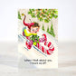 Mellow Monkey mini Christmas card featuring a vintage-style elf illustration on a candy cane sled in the snow
