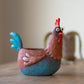 Mellow Monkey Wilbur the Rooster Blobhouse Planter, a handcrafted poly-resin pot with a whimsical design, featuring blue and red colors.