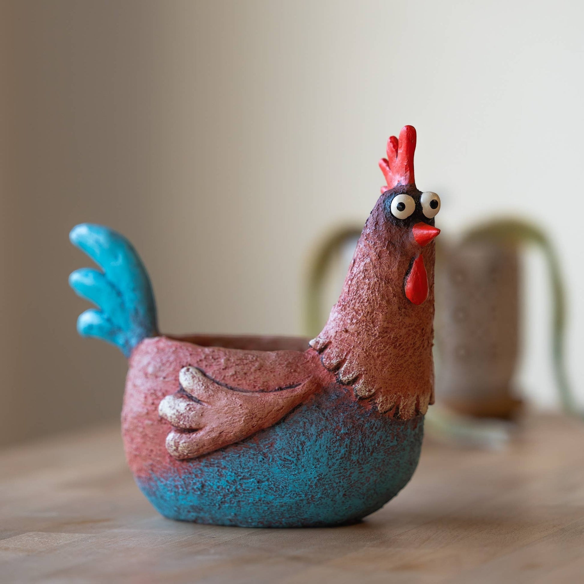 Mellow Monkey Wilbur the Rooster Blobhouse Planter, a handcrafted poly-resin pot with a whimsical design, featuring blue and red colors.