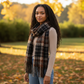 Mellow Monkey Rory classic plaid fringe scarf in brown and black brushed acrylic worn by a woman in an autumn park