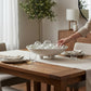 Mellow Monkey 18-inch round capiz shell bowl with ball feet as a coastal dining table centerpiece
