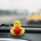 Mellow Monkey yellow rubber duck with a winking eye holding a red heart that says I Ducking Love You on a dashboard