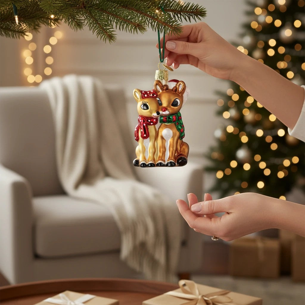 Mellow Monkey Rudolph and Clarice blown glass holiday ornament, 3.5-in. Two golden reindeer with red and green scarves.